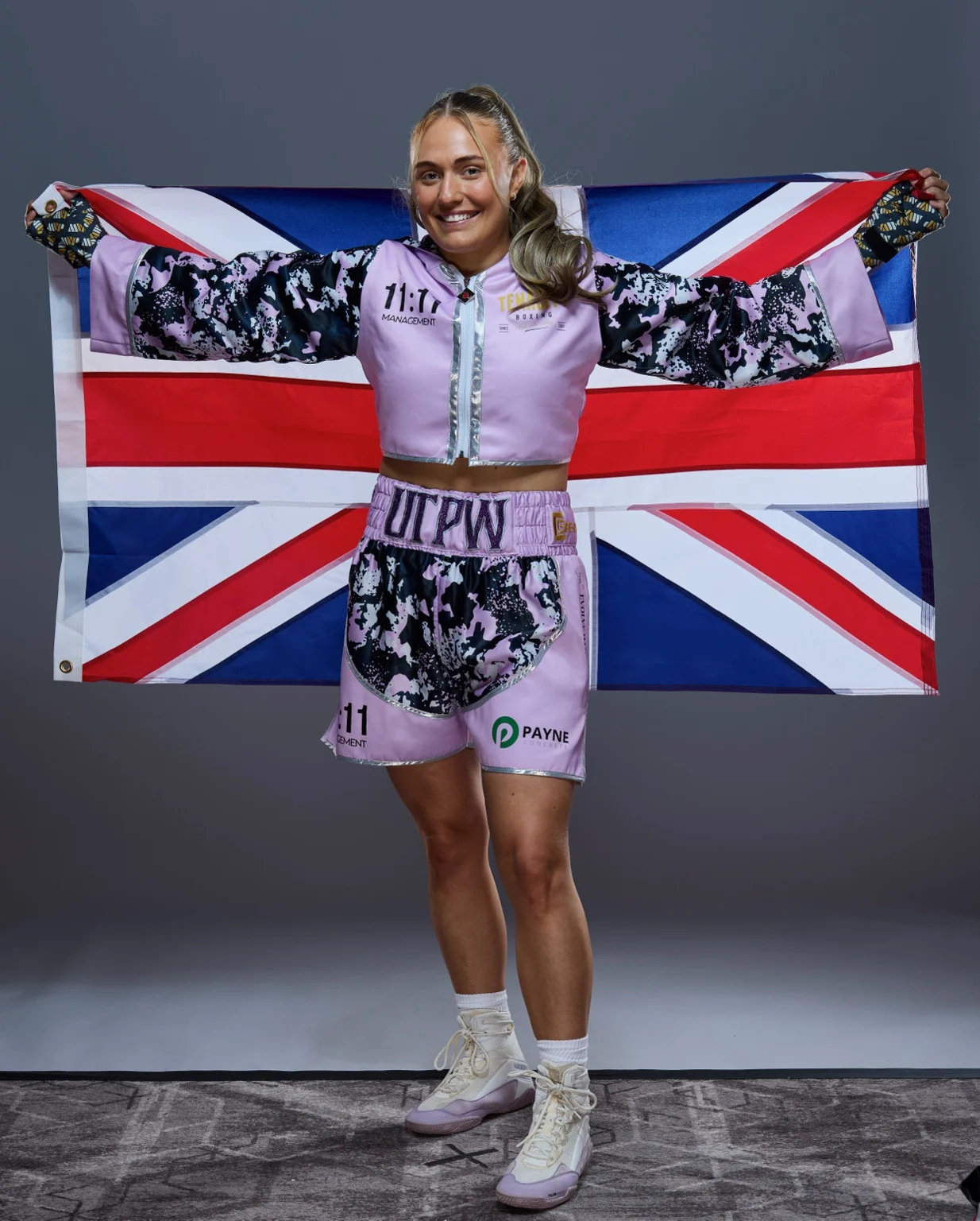 Gemma Paige Richardson holding the Union Flag in her boxing kit